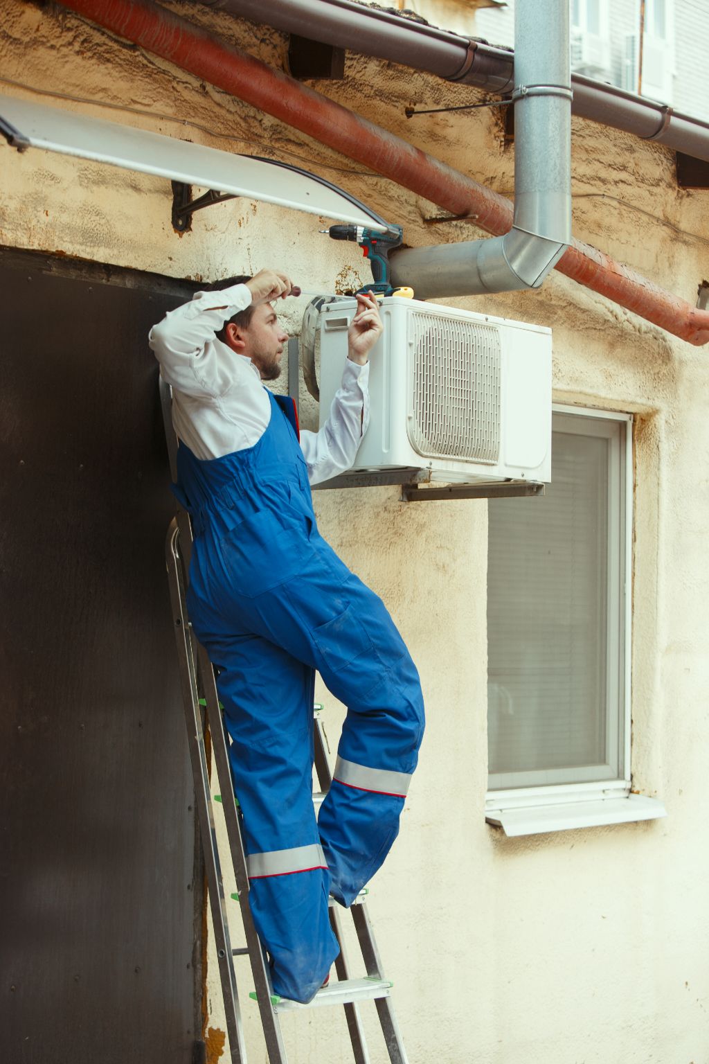 HVAC technician working on a capacitor